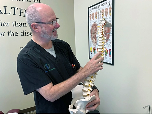 Chiropractor Parker CO Scott Godsey Holding Spine